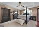Elegant primary bedroom with tray ceiling, ceiling fan, and lots of natural light at 341 Jodeco Station E Cir, Stockbridge, GA 30281