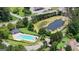 An aerial view features a community pool surrounded by lush greenery and a tranquil pond with lily pads at 341 Jodeco Station E Cir, Stockbridge, GA 30281