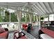 Inviting screened-in porch with cozy seating, outdoor decor, and serene views at 341 Jodeco Station E Cir, Stockbridge, GA 30281