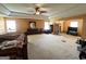 This is a primary bedroom with carpet, ceiling fan, and tray ceiling at 4466 Estate St, South Fulton, GA 30349