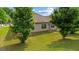 Well-maintained backyard featuring a lush lawn and mature trees, offering privacy and shade at 697 Emporia Loop, Mcdonough, GA 30253