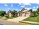 Attractive single-story home with a wide driveway and manicured front lawn at 697 Emporia Loop, Mcdonough, GA 30253