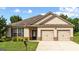 Charming single-story home with a well-manicured lawn and attached two-car garage at 697 Emporia Loop, Mcdonough, GA 30253