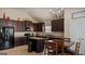 Modern kitchen with stainless steel appliances, dark cabinetry, and a center island offers ample workspace at 697 Emporia Loop, Mcdonough, GA 30253
