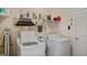 A well-organized laundry room equipped with modern washer and dryer and ample storage shelving at 697 Emporia Loop, Mcdonough, GA 30253