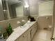 Bathroom featuring a long countertop, a sink, neutral tiles, and a window that provides natural light at 7111 Indian Creek Sw Cir, Covington, GA 30014