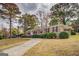 Attractive brick home with a long driveway and carport, surrounded by well-manicured landscaping at 7111 Indian Creek Sw Cir, Covington, GA 30014