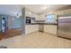 Bright kitchen featuring white cabinets, stainless steel appliances, and tile flooring for easy maintenance at 7111 Indian Creek Sw Cir, Covington, GA 30014
