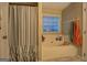 Relaxing bathroom with soaking tub and window allowing for natural light at 160 Laurel Ln, Social Circle, GA 30025