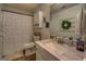 Bright bathroom with single sink and shower curtain at 160 Laurel Ln, Social Circle, GA 30025