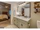 Bathroom features a double vanity sink with nice fixtures, next to the main bedroom at 160 Laurel Ln, Social Circle, GA 30025