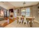 Dining room features farmhouse table and leads to open concept living with fireplace at 160 Laurel Ln, Social Circle, GA 30025