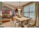 Open dining area featuring an industrial pendant light and hardwood floors and natural light at 160 Laurel Ln, Social Circle, GA 30025