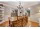 Dining room with hardwood floors, a wooden table, seating for six, and a view into the kitchen at 160 Laurel Ln, Social Circle, GA 30025