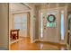 Welcoming entryway with hardwood floors and a view into dining room with natural light at 160 Laurel Ln, Social Circle, GA 30025