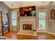 Living room featuring a fireplace, hardwood floors, and easy access to the outdoors at 160 Laurel Ln, Social Circle, GA 30025