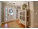 Inviting foyer with hardwood floors, decorative cabinet, and a charming front door with sidelights at 160 Laurel Ln, Social Circle, GA 30025