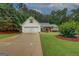Charming home with a two-car garage, manicured lawn, and inviting front porch with rocking chairs at 160 Laurel Ln, Social Circle, GA 30025