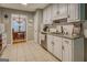 Kitchen featuring white cabinetry, granite countertops, stainless steel appliances, and tiled flooring at 160 Laurel Ln, Social Circle, GA 30025