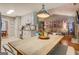 Open kitchen with white cabinets and views of the living room and dining area at 160 Laurel Ln, Social Circle, GA 30025