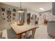 Bright kitchen with wooden table, stainless steel refrigerator, white cabinets, and decorative light fixture at 160 Laurel Ln, Social Circle, GA 30025