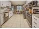 Bright kitchen with white cabinets, stainless steel appliances, and adjacent dining area at 160 Laurel Ln, Social Circle, GA 30025