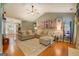 Bright living room featuring vaulted ceilings, hardwood floors, and comfortable neutral furniture at 160 Laurel Ln, Social Circle, GA 30025