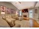 Cozy living room with a fireplace, hardwood floors, comfortable seating, and a bright, open feel at 160 Laurel Ln, Social Circle, GA 30025