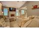 Comfortable living room with a fireplace, hardwood floors, and seamless access to dining area at 160 Laurel Ln, Social Circle, GA 30025