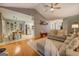 Open-concept living room with hardwood floors, neutral sofa, and seamless flow to the dining and kitchen areas at 160 Laurel Ln, Social Circle, GA 30025