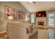 Warm living room featuring a fireplace, hardwood floors, comfortable seating, and natural light at 160 Laurel Ln, Social Circle, GA 30025