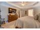 Bedroom with a dresser, television, and a view into the attached bathroom and closet at 160 Laurel Ln, Social Circle, GA 30025