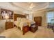Bedroom with a wooden bed, plush bedding, tray ceiling, and matching wood furniture at 160 Laurel Ln, Social Circle, GA 30025