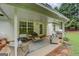 Covered patio with comfortable seating and a grill, perfect for outdoor entertaining at 160 Laurel Ln, Social Circle, GA 30025
