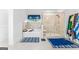 Bright bathroom featuring a soaking tub, separate glass-enclosed shower, and stylish blue accents at 412 Culloden Moor, Mcdongough, GA 30253