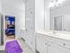 Bright bathroom with a modern vanity, tile flooring, and access to an adjacent bedroom, offering convenience and style at 412 Culloden Moor, Mcdongough, GA 30253