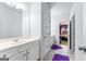 Bright bathroom with a modern vanity, tile flooring, and access to an adjacent bedroom, offering convenience and style at 412 Culloden Moor, Mcdongough, GA 30253