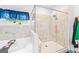 Bright bathroom featuring a soaking tub, separate glass-enclosed shower, and stylish blue accents at 412 Culloden Moor, Mcdongough, GA 30253