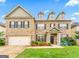 Charming two-story home with a brick facade, manicured lawn, and a two-car garage at 412 Culloden Moor, Mcdongough, GA 30253