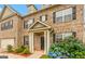 Inviting brick home entrance with a covered porch, black front door, and colorful landscaping at 412 Culloden Moor, Mcdongough, GA 30253