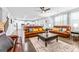 Spacious living room featuring hardwood floors, a ceiling fan, and comfortable leather sofas at 412 Culloden Moor, Mcdongough, GA 30253