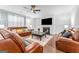 Comfortable living room with leather sofas, fireplace, and a ceiling fan at 412 Culloden Moor, Mcdongough, GA 30253