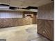 Spacious unfinished basement with wood paneling, drop ceiling, and potential for customization at 984 Morrow Rd, Morrow, GA 30260