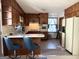 Vintage-style kitchen featuring wood cabinetry, breakfast bar, and a view to backyard at 984 Morrow Rd, Morrow, GA 30260