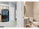View of the kitchen leading to a half bath with toilet and pedestal sink at 4862 Park Cir, Atlanta, GA 30349
