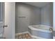 Cozy bathroom nook showing large soaking tub and tiled floors at 4862 Park Cir, Atlanta, GA 30349