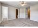 A spacious bedroom with neutral carpet showing doors to bathroom and closet at 4862 Park Cir, Atlanta, GA 30349