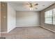 A large bedroom with soft carpet, fan, and ample light from window at 4862 Park Cir, Atlanta, GA 30349