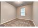 Simple bedroom with neutral carpet, walls, and single window for natural light at 4862 Park Cir, Atlanta, GA 30349