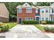 Charming red brick townhouse featuring a well-maintained front yard and a private driveway at 4862 Park Cir, Atlanta, GA 30349